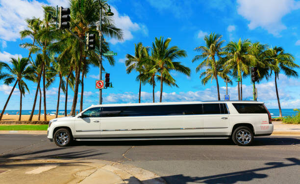 Honolulu, Oahu, Hawaii - November 04, 2019: stretch limo at Waikiki beach with unidentified people. Waikiki is a neighbourhood of Honolulu, most famous for Waikiki beach, almost entirely man-made