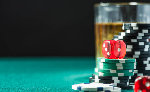 Poker Chips Stacks Pile and Dices on Green Casino Table. Gambling and Betting Background.