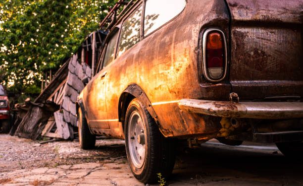 old dusty car parked outside house